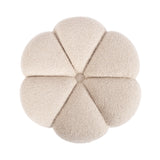 Top view of a round, beige, tufted ottoman shaped like a flower with soft, segmented petals and a central button.