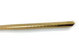Close-up of the handle of a golden teaspoon with a hammered texture and smooth, rounded end against a white background.