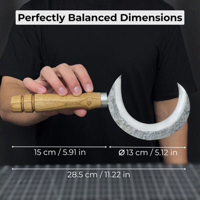 Hand-forged ritual witch sickle with crescent-shaped steel blade and wooden handle, including leather sheath