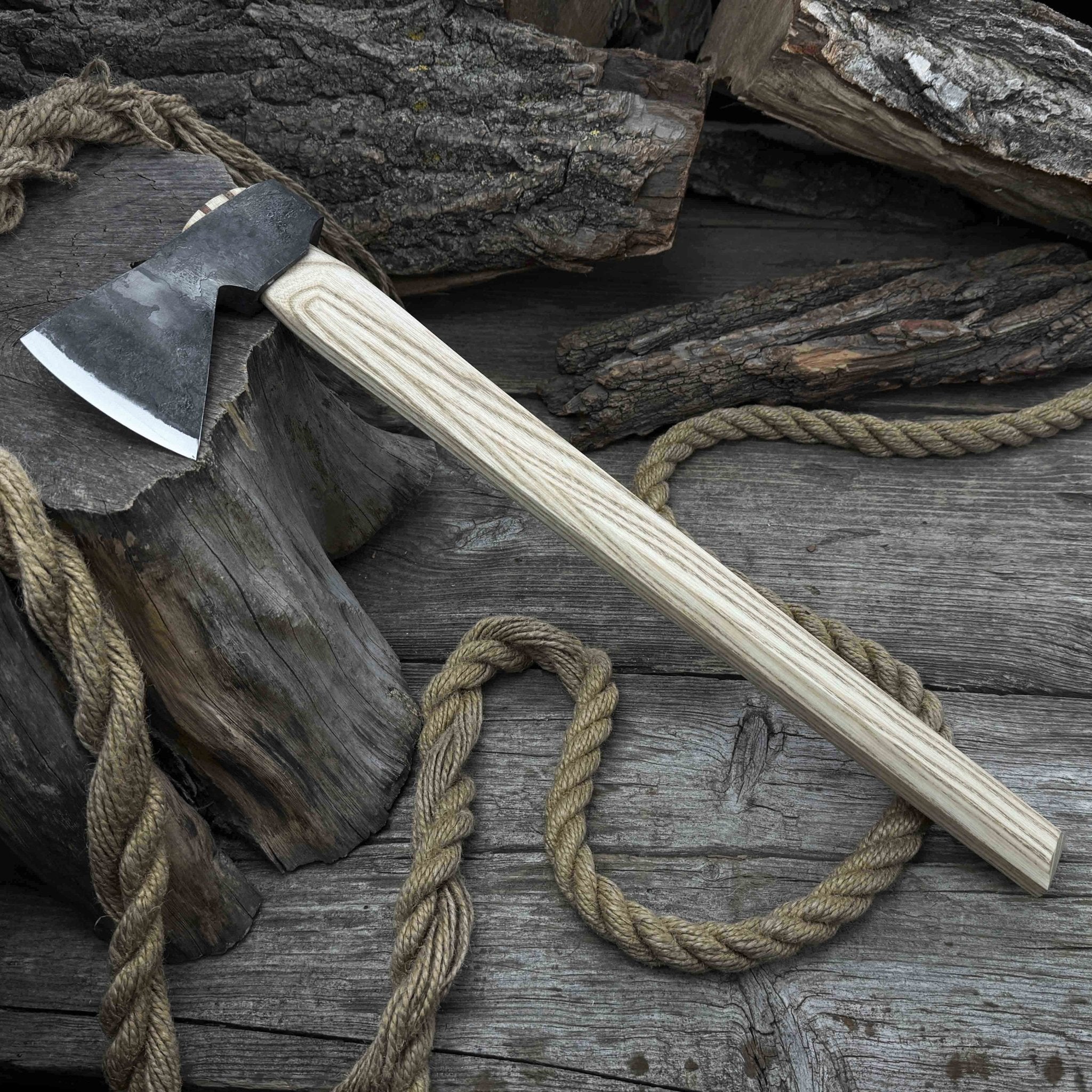 Hand-forged bushcraft hatchet with leather back sheath and ash handle