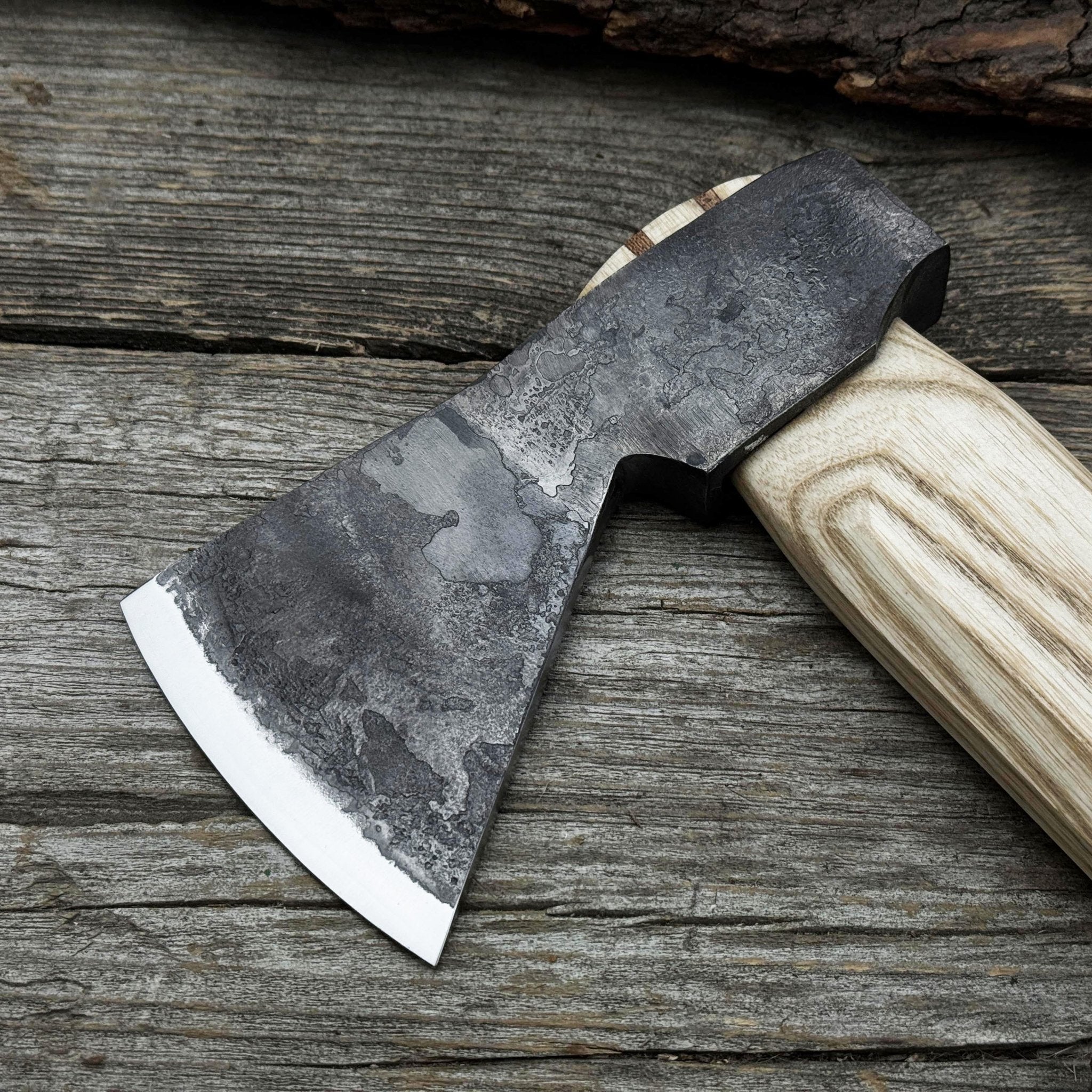 Hand-forged bushcraft hatchet with leather back sheath and ash handle