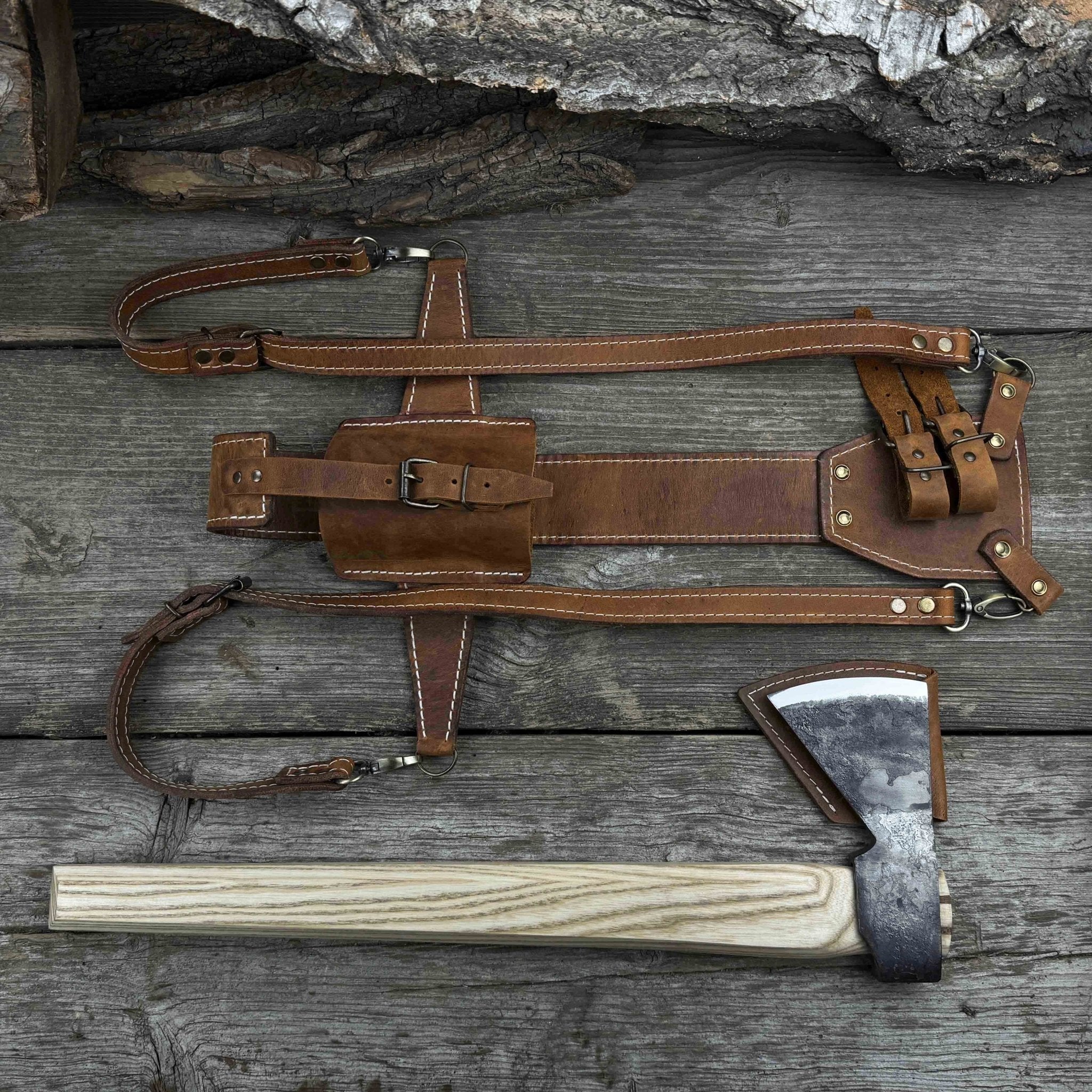 Hand-forged bushcraft hatchet with leather back sheath and ash handle