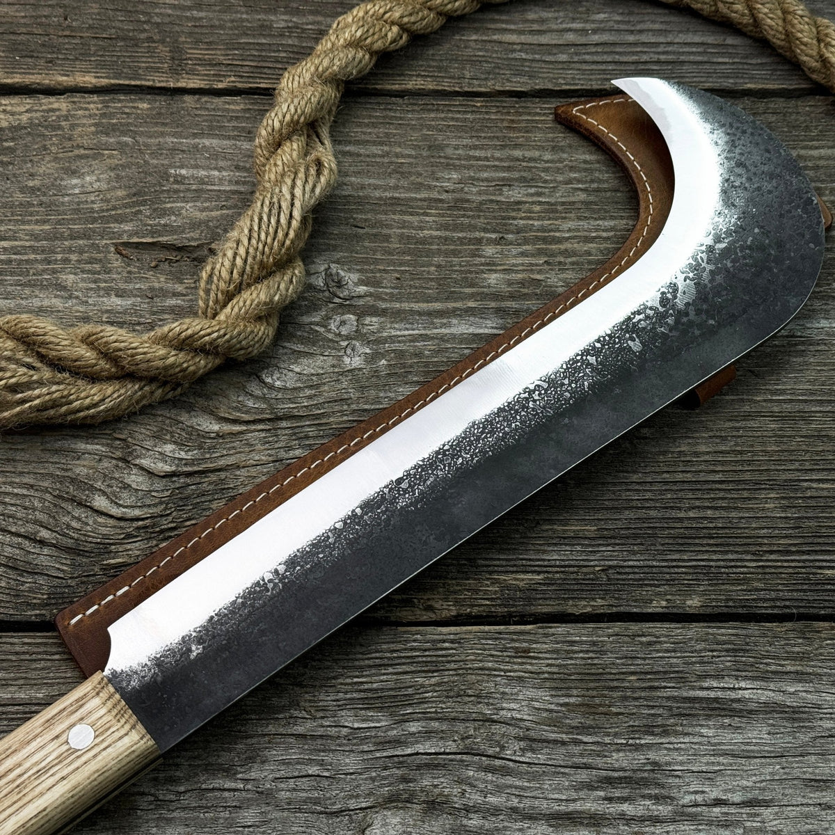 Hand-forged bushcraft knife with carbon steel blade and ash wood handle by Sharky Forged Steel Tools