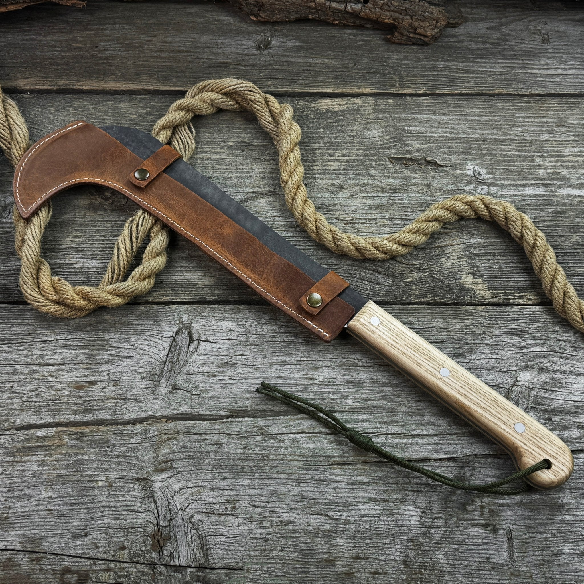 Hand-forged bushcraft knife with carbon steel blade and ash wood handle by Sharky Forged Steel Tools