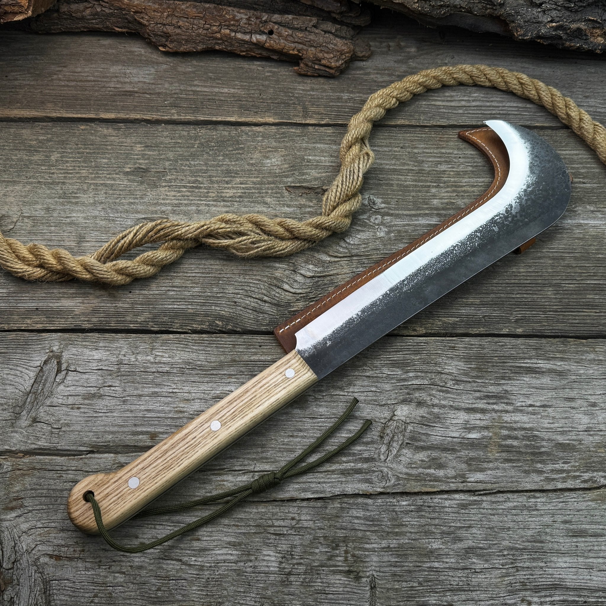 Hand-forged bushcraft knife with carbon steel blade and ash wood handle by Sharky Forged Steel Tools