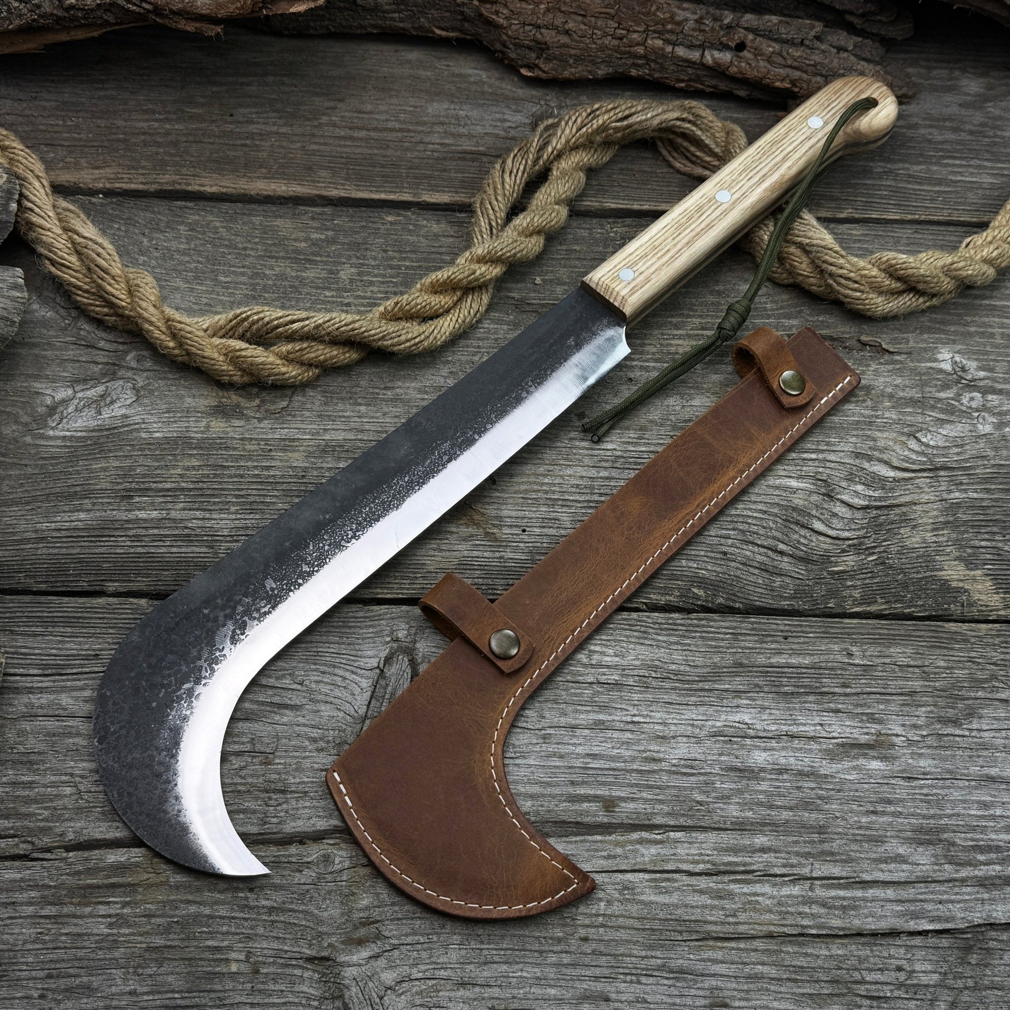 Hand-forged bushcraft knife with carbon steel blade and ash wood handle by Sharky Forged Steel Tools