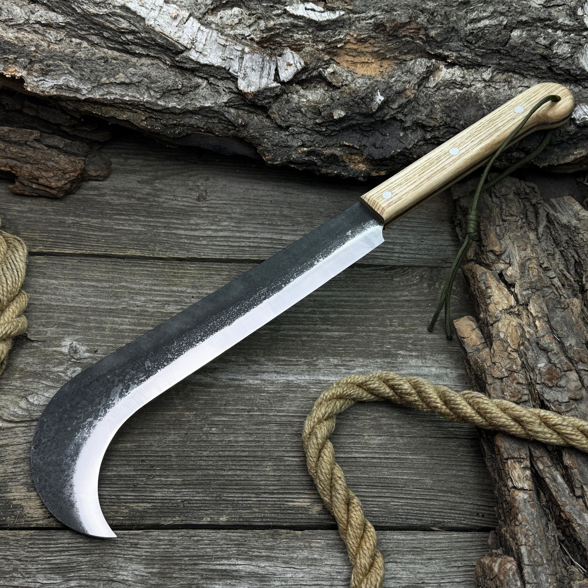 Hand-forged bushcraft knife with carbon steel blade and ash wood handle by Sharky Forged Steel Tools