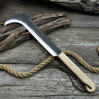 Hand-forged bushcraft knife with carbon steel blade and ash wood handle by Sharky Forged Steel Tools