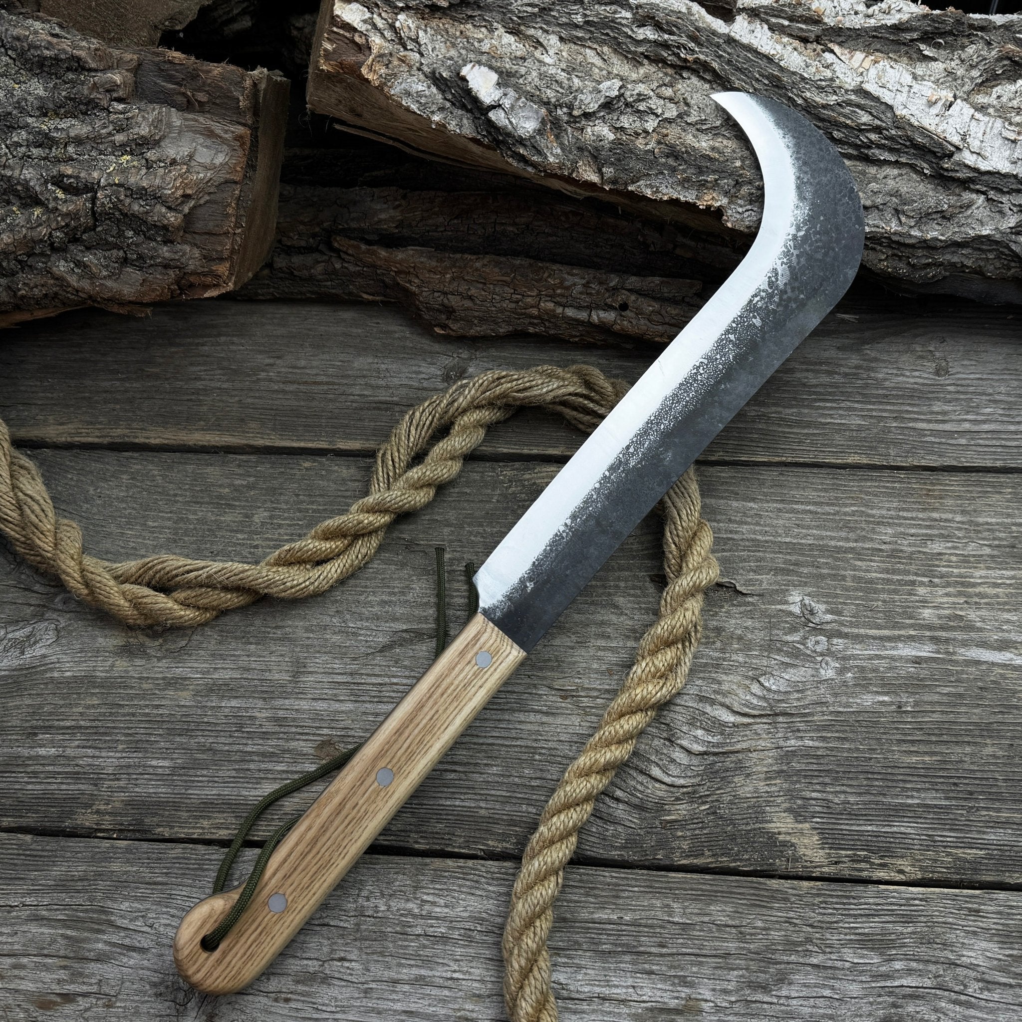 Hand-forged bushcraft knife with carbon steel blade and ash wood handle by Sharky Forged Steel Tools