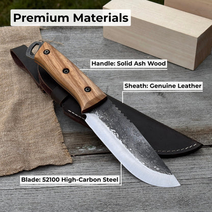 Hand-forged camping knife with 12.5 cm carbon steel blade and ash wood handle, with leather sheath