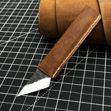 Hand-forged kiridashi knife with razor-sharp carbon steel blade and leather sheath