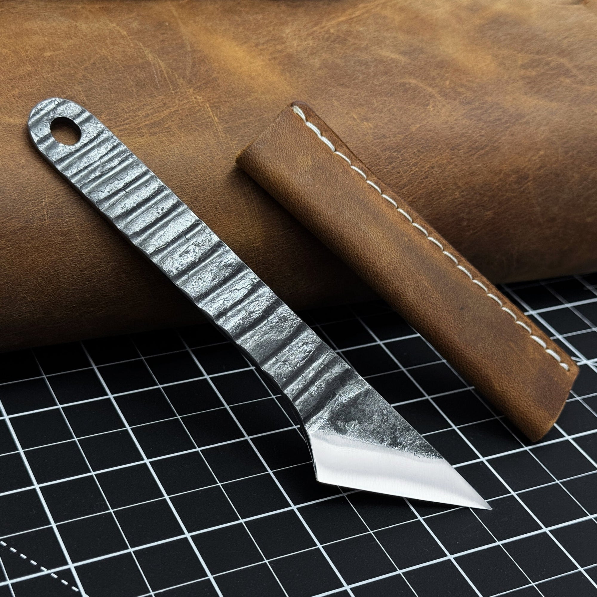 Hand-forged kiridashi knife with razor-sharp carbon steel blade and leather sheath