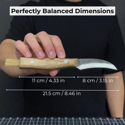 Hand-forged mushroom foraging knife with carbon steel blade, ash wood handle, built-in brush, and leather sheath