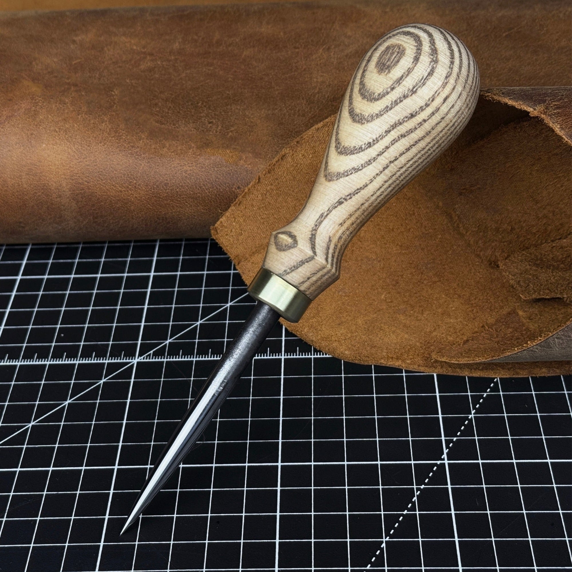 Hand-forged leatherworking awl with ash wood handle by Sharky Forged Steel Tools
