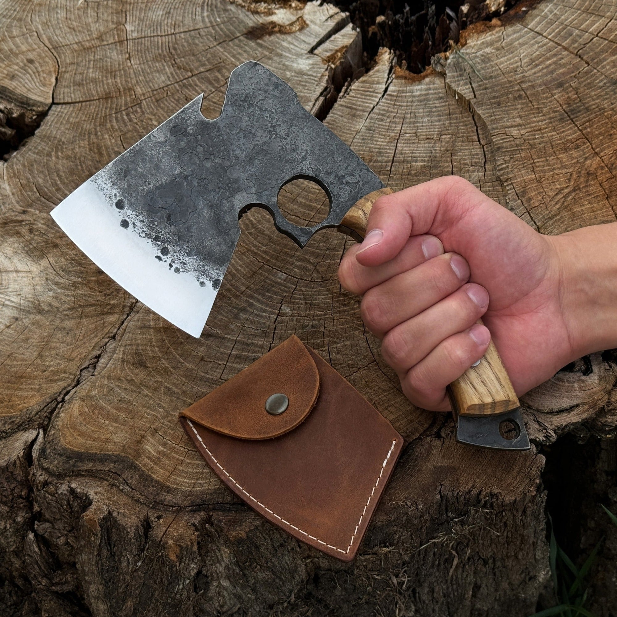 Hand-forged small camping axe with curved ash wood handle and leather sheath