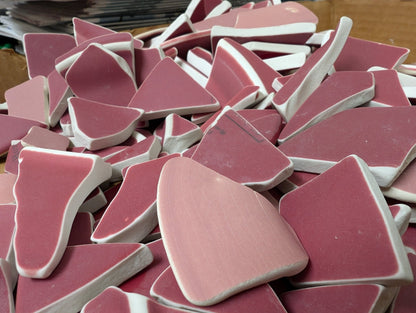 Assorted hand-tumbled pottery pieces in earthy colors for mosaic crafts
