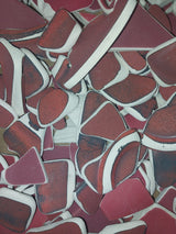 Assorted hand-tumbled pottery pieces in earthy colors for mosaic crafts