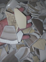 Assorted hand-tumbled pottery pieces in earthy colors for mosaic crafts