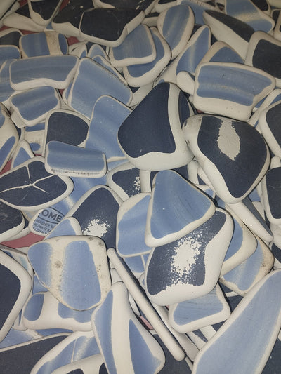 Assorted hand-tumbled pottery pieces in earthy colors for mosaic crafts