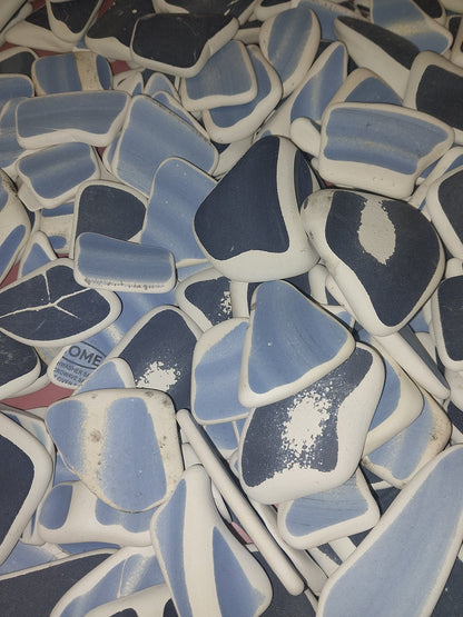 Assorted hand-tumbled pottery pieces in earthy colors for mosaic crafts