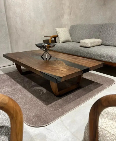 Handcrafted resin coffee table with smoke-colored resin river and solid walnut legs