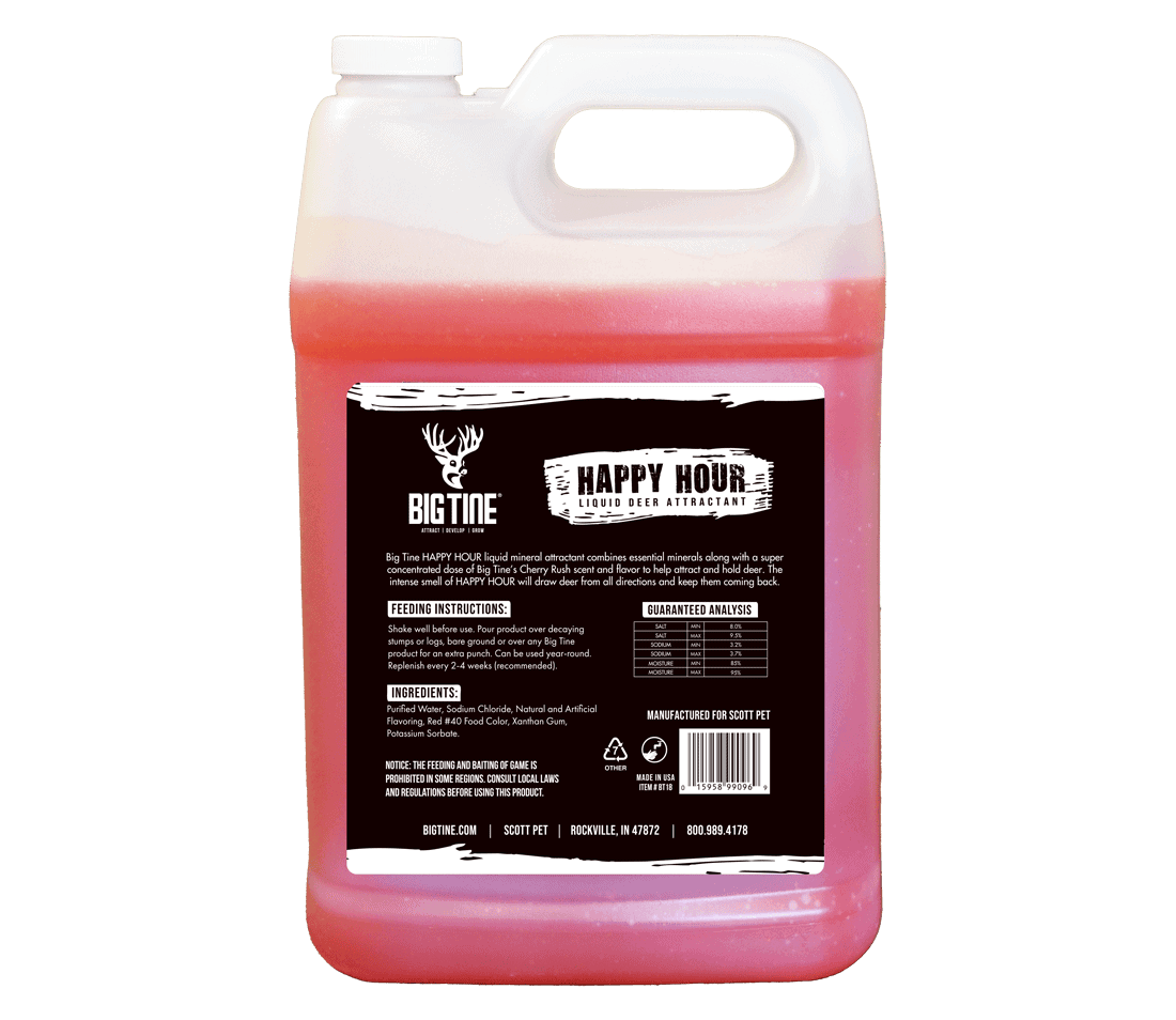Clear plastic jug with red liquid labeled Big Tine Happy Hour liquid deer attractant and feeding information on a black and white label.