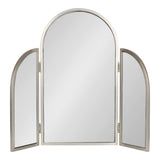 Tri-fold mirror with three arched panels in brushed silver metal frames, with the central panel larger than the two side panels that fold inward.