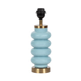 Table lamp base with stacked rounded blue ceramic sections and brass accents, shown without a lampshade against a white background.