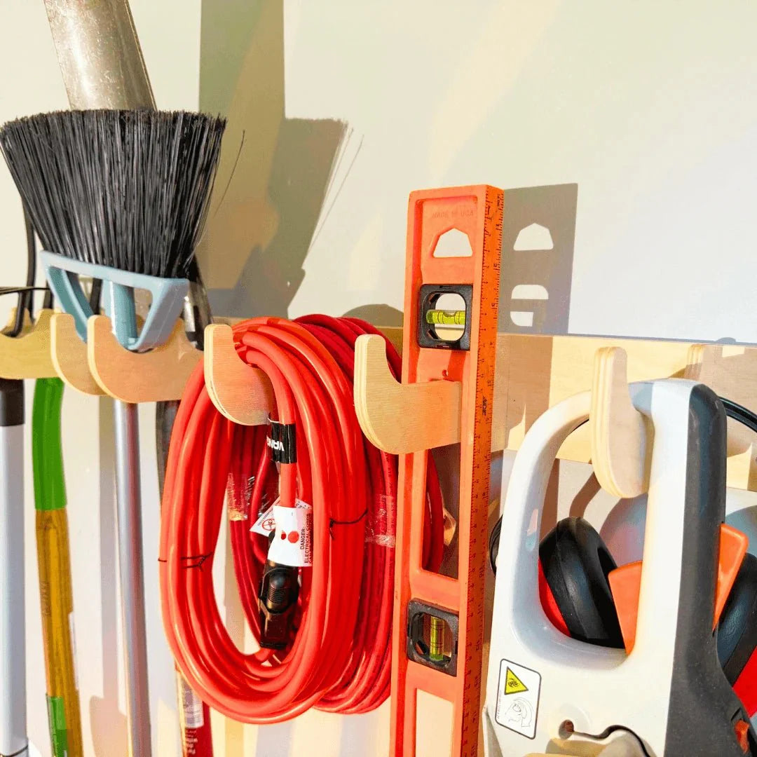 Heavy-Duty Garage Tool and Misc. Hook Rack by HangThis Up mounted on a garage wall holding various tools and equipment