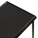 Close-up view of a sleek black metal side table with a smooth, slightly hammered top and thin, tubular legs, showcasing a minimalist modern design.