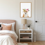 Framed canvas of a fox with a floral crown, hanging above a white nightstand with a beige lamp and a small plant, beside a beige headboard and white door.