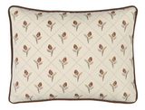 Cream rectangular pillow cover featuring a repeating pattern of brown pinecone-like motifs with green stems, framed by brown piping along the edges.