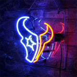 Neon sign shaped like a Houston Texans football helmet with blue, white, and red glowing outlines mounted on a dark textured wall.