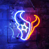 Neon sign depicting the Houston Texans logo with bright red and blue lights, mounted on a transparent panel against a textured dark wall background.