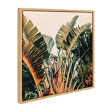 Framed canvas print showing large green and orange tropical banana leaves against a pale sky background, captured in vibrant natural colors and close-up composition.
