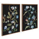 Two framed canvas artworks showing abstract foliage with green leaves and blue flowers on textured black backgrounds, arranged side by side with wooden frames.