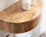 Curved floating wood side table with natural grain and warm tones, mounted on a light-colored wall with two white ceramic vases on top.