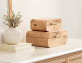 Two smooth, rectangular wooden stacking boxes with rounded edges and decorative burl wood patterns, placed on a white surface beside a white vase with dry branches and stacked books.
