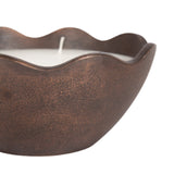 Close-up of a brown metal candle bowl with a scalloped edge and a white candle inside, shown against a white background.