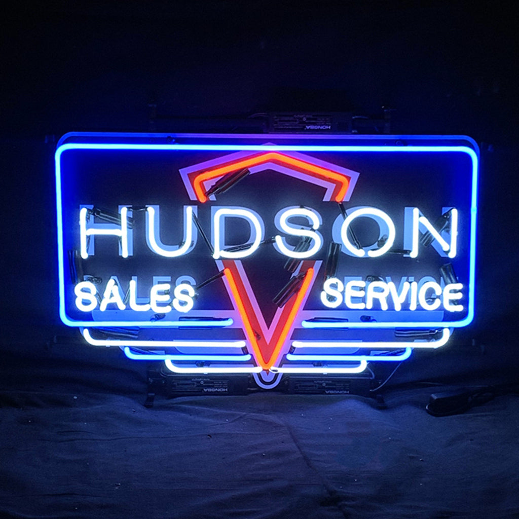 Hudson Sales Service Neon Sign Light showing glowing blue neon letters on acrylic printed backing hung indoors.