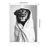 Black and white close-up photo of a lioness wrapped in a soft white towel, with expressive eyes and detailed fur texture visible.