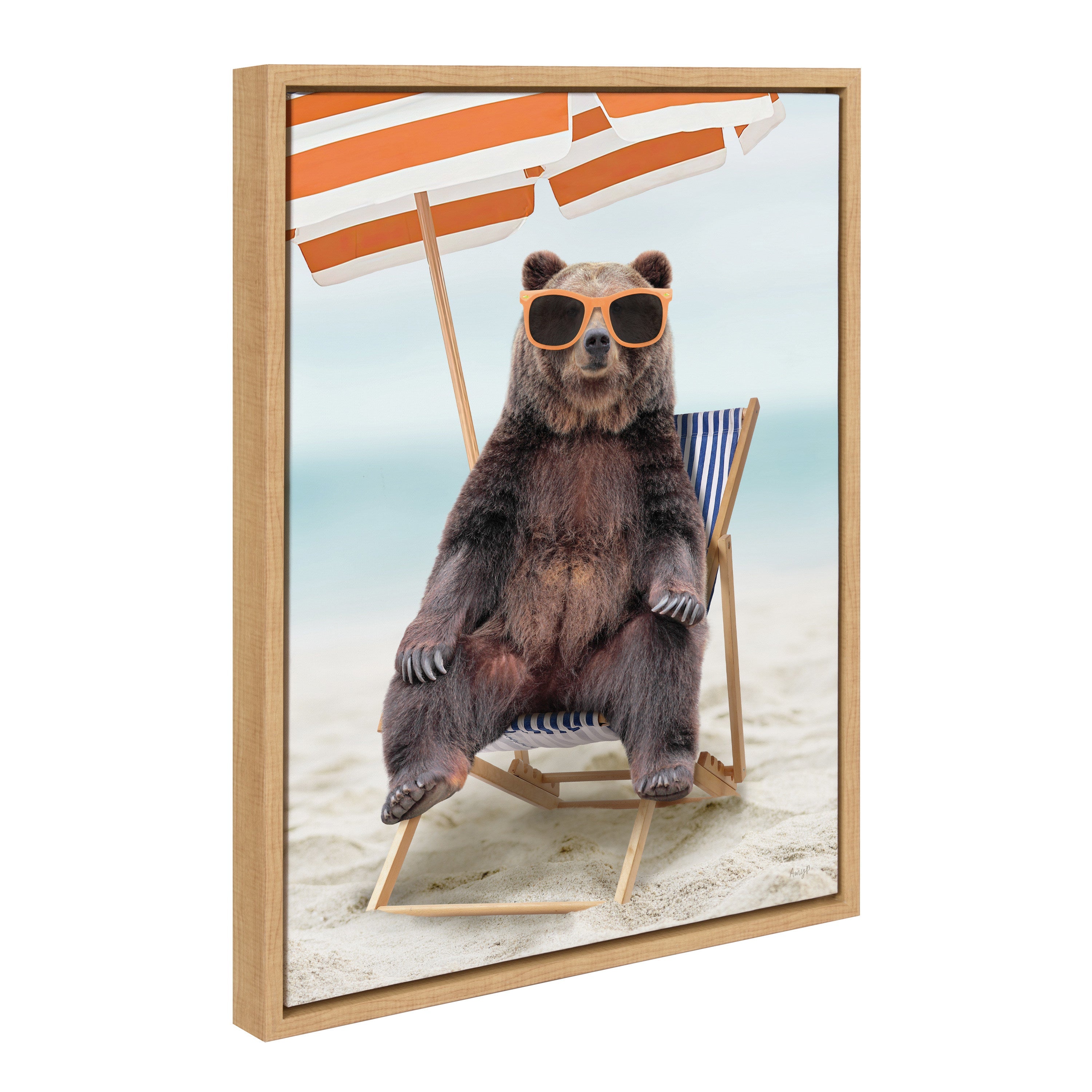 Framed canvas art showing a bear sitting in a beach chair printed in natural tones
