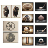 Set of ten framed art prints featuring two Highland cattle portraits and sports equipment including football, hockey stick, basketball, baseball, and soccer ball on rustic backgrounds.