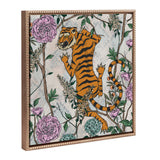 Framed canvas featuring an orange and black striped tiger climbing among detailed green vines and pink and blue flowers on a light patterned background.