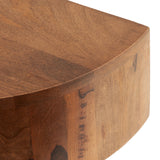 Close-up of a smooth, rounded corner on a warm-toned wooden slab with natural grain variations and a rich, polished finish.