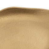 Close-up of a gold-toned oval decorative tray with a textured, slightly uneven surface and gently raised edges.