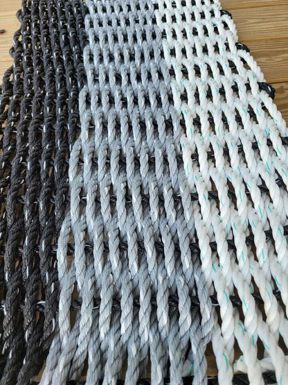 Handmade rope mat made from lobster rope in black, gray, and white colors