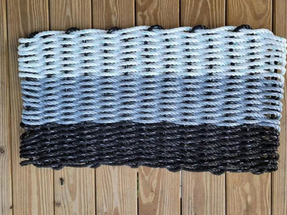 Handmade rope mat made from lobster rope in black, gray, and white colors