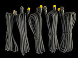 Six neatly coiled black cables with yellow-tipped connectors and one USB connector, arranged vertically against a black background.