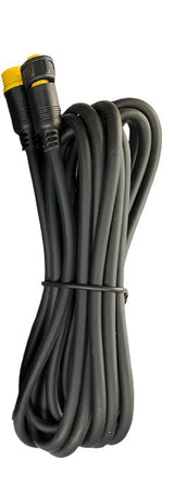 Coiled black TrailVue camera cable extension with yellow-tipped connectors at both ends, held together by a black plastic twist tie.